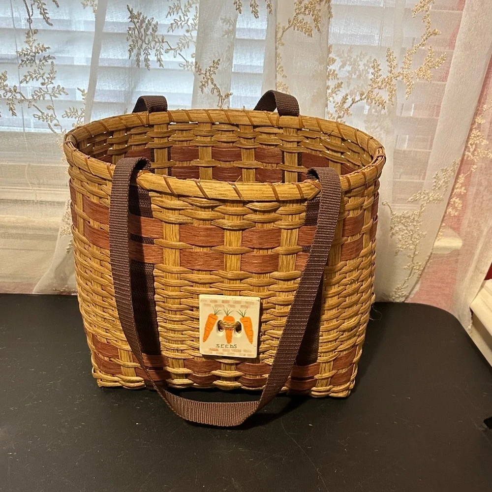 Woven vegetable basket with handles — carrot plaque decor